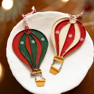 Vintage Christmas hot air balloon metal ornaments with snowflake patterns in red and green