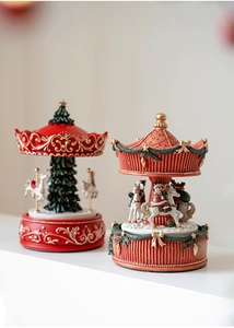 Close-up of Santa Claus carousel and Christmas tree train music box ornaments
