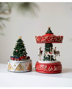 Detail of resin Christmas tree music box with miniature train and carousel horse