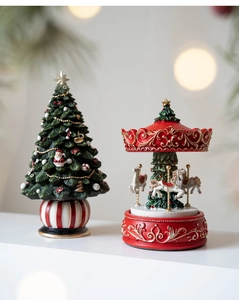 Detailed resin Christmas tree and carousel music box ornaments with festive decorations
