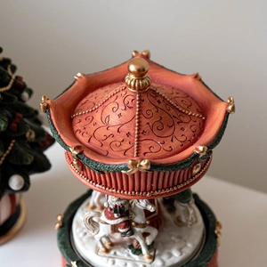 Vintage red Christmas carousel music box with Santa on white horse and gold engraving