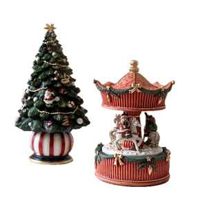 Resin Christmas music box set with decorated tree and Santa carousel figurines