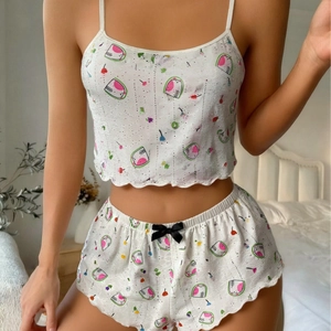 Women's two-piece pajama set with heart print camisole top and matching ruffled shorts