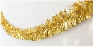 Close-up of fluffy metallic gold tinsel garland for Christmas and party decorations