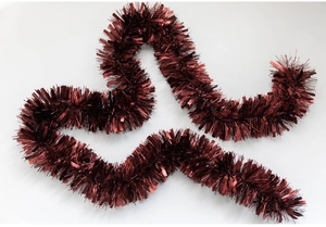 Close-up of deep red metallic tinsel garland with reflective texture for Christmas decor