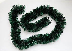 Detail of dark green tinsel garland with a glossy metallic finish for Christmas decoration