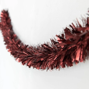 Deep red tinsel garland with metallic luster for festive Christmas tree and mall decoration