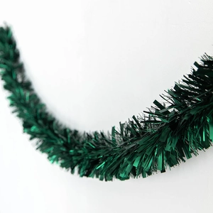 Deep green shiny Christmas tinsel garland with metallic glitter for festive tree decoration