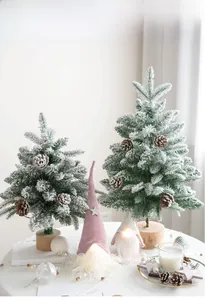 Detail of flocked Christmas trees with pine cones and glowing Nordic gnomes on wood base