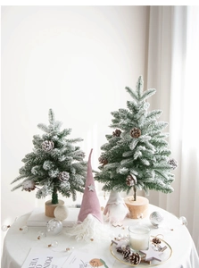Detail of snowy mini Christmas trees with pine cones and plush Nordic gnomes on wood base