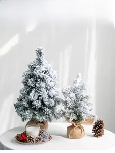 Flocked tabletop Christmas trees with snow effect, burlap base, pine cones and red berries