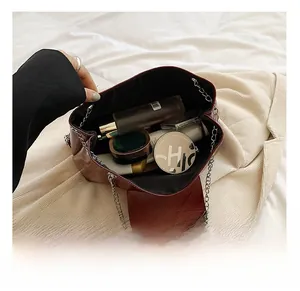 Interior view of the burgundy tote bag showing capacity for cosmetics and skincare products