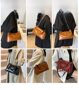 Close-up of gloss finish tote bags with chain straps and metallic bow buckles in four colors