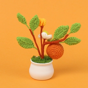 Handmade crochet potted plant with orange fruit and flowers for housewarming gift