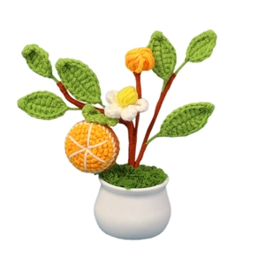 Handmade crochet orange potted plant with white blossom and green leaves for home decor