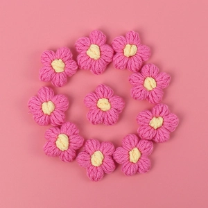 Handmade crochet puff flowers in pink and yellow for DIY clothing and accessories