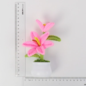 Size demonstration of a handmade crochet pink lily potted plant, 18cm height for desk decor