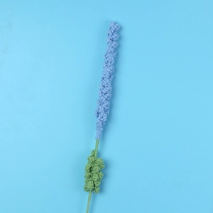 Macro detail of handmade crochet lavender flower with intricate light blue yarn texture