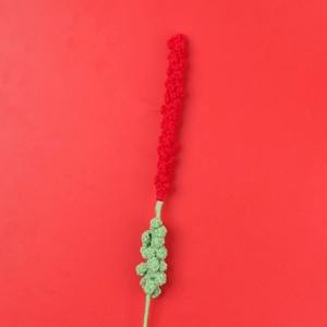 Detailed view of handmade crochet lavender stem with red spiral top and green yarn texture