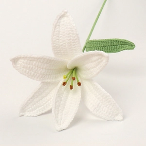 Handmade crochet white lily flower with green leaves for home decor and cozy ambiance
