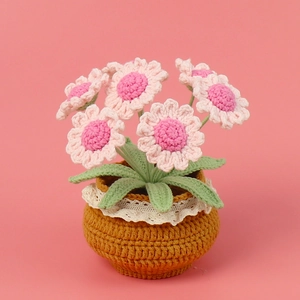 Handmade crochet pink daisy flower pot with lace detail for desktop decor