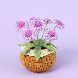 Handmade crochet daisy potted plant with purple and pink flowers on light purple background