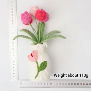 Macro view of handmade crochet tulip potted plant with measuring scale for size 110g