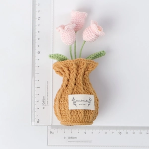 Handmade crochet tulips in a knitted vase with height measurement scale detail