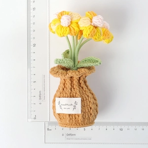 Detail view of handmade crochet flower pot with size scale on white background
