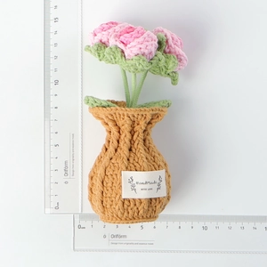 Detail of pink crochet tulip centerpiece with a handmade label and size measurements