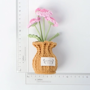 Detail of handmade crochet pink flower pot with HandMade WITH LOVE label 15.5cm height