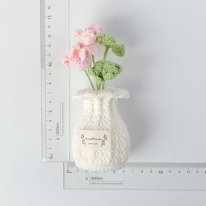 Handmade crochet pink flowers in pot showing dimensions of 13cm height and 6cm width