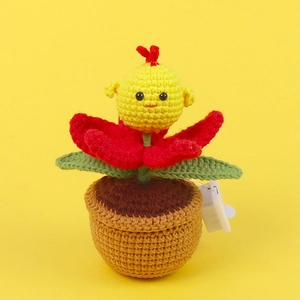 Macro shot of handmade crochet yellow flower doll in brown pot with electronic light switch