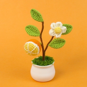 Handmade crochet orange fruit potted plant with leaves and flower in white pot