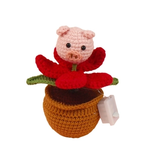 Handmade crochet pig potted plant decoration with pink head and green leaves