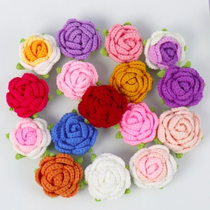 Flat lay of colorful handmade crochet rose flower heads for DIY crafts and accessories