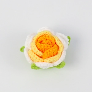 Detail of handmade crochet rose with orange and yellow gradients for DIY crafts