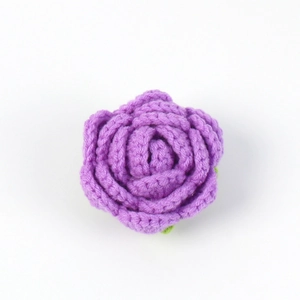 Macro view of handmade purple crochet rose flower head with detailed yarn stitching