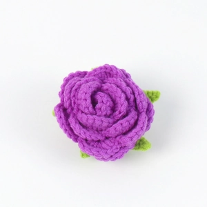 Detail of handmade purple crochet rose with green leaves for DIY bouquet and crafts