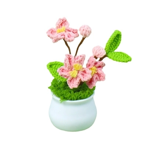 Handmade crochet cherry blossom plant in a white ceramic pot for home decoration