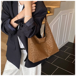 Close-up of brown leopard print tote bag with soft texture and leather logo patch