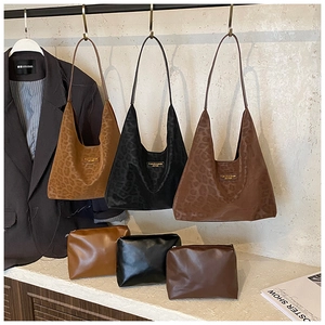 Three leopard print hobo bags and matching pouches in caramel, black, and coffee colors