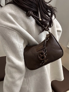 Minimalist dark brown underarm dumpling bag with leather texture and knot shoulder strap