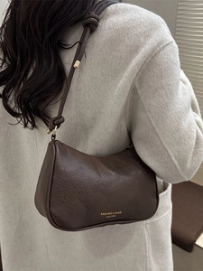 Dark brown textured leather hobo bag featuring a knot strap and golden brand logo