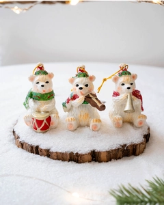 Detailed view of resin Christmas bear figurines playing instruments on snowy wood