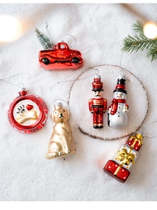 Detailed view of six Christmas glass ornaments including snowman, dog, and nutcracker