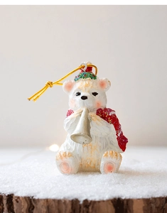 Macro view of polar bear ornament with red scarf playing trombone on snow wood base