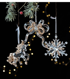 Close-up of clear acrylic Christmas ornaments with gold sequins and glitter details