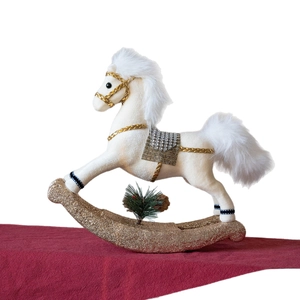 Ivory flocked rocking horse Christmas ornament with gold trim on red festive background