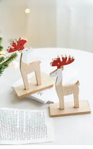 Close-up of wooden reindeer table ornaments with red hand-painted details and natural grain